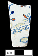 Printed underglaze plate with red and yellow clobbering.